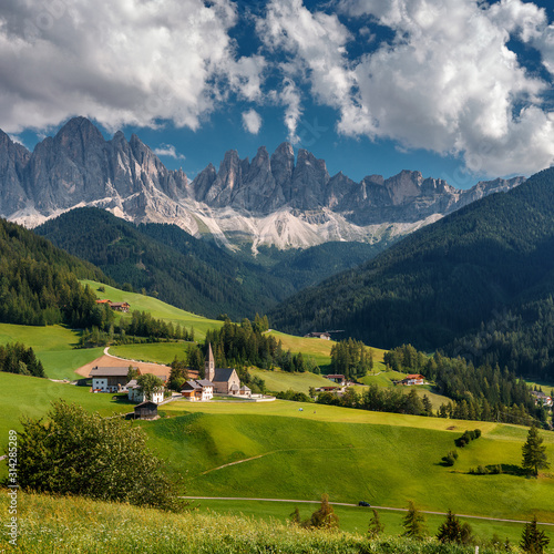 Wonderful Sunny Landscape of Dolomites Alps. Scenic Imege of Alpine Valley With Majestic Rocky Mountains peaks and perfect sky, Beautiful View on Famouse place Santa Maddalena, Dolomiti, Italy