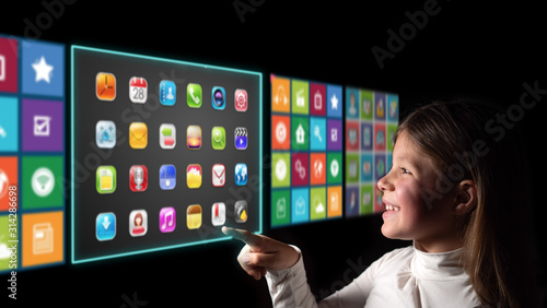 A little girl is touching a futuristic latest technology augmented reality virtual screen with holographic multimedia connections. Concept of future and communication with the digital world.