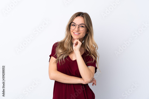 Young woman over isolated white background with glasses and smiling