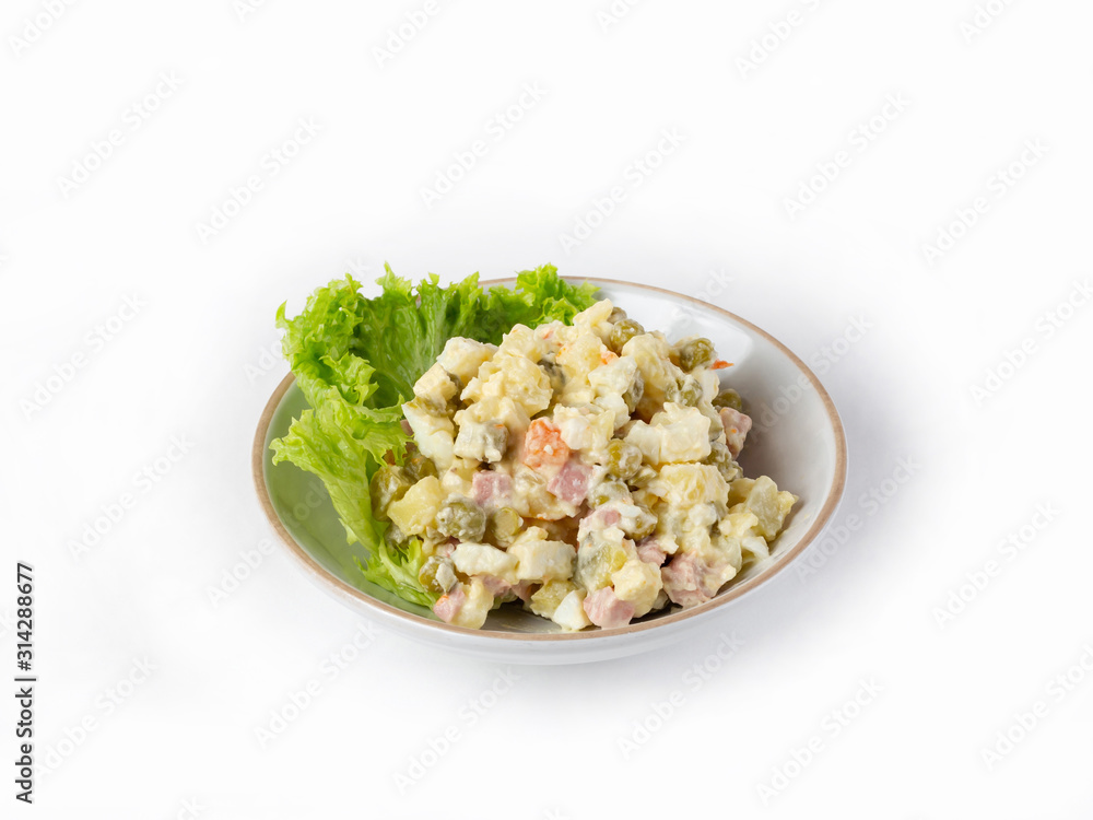 Portion of salad Olivier with lettuce in a bowl on a white background, side view Portion of salad Olivier with lettuce in a bowl on a white background, side view