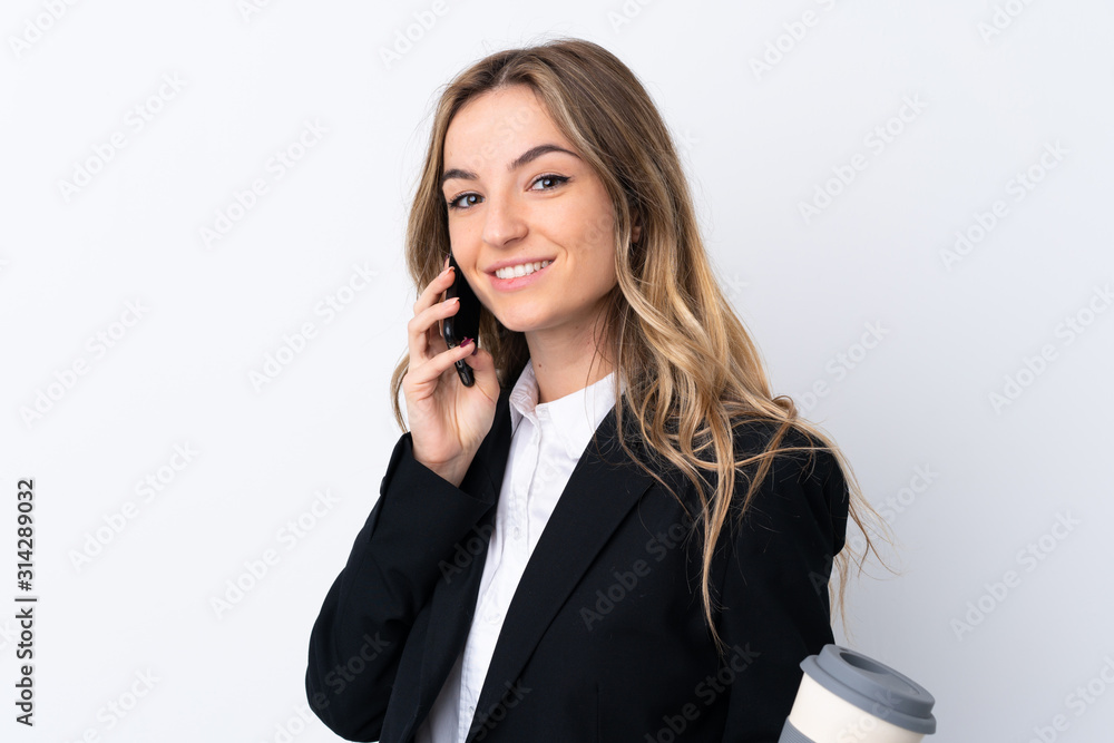 Young business woman over isolated white background holding a cup of coffee and a phone Young business woman over isolated white background holding a cup of coffee and a phone