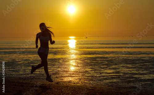 girl running by the sea on the beach