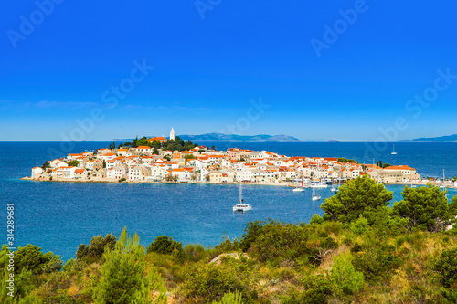 Croatia, panorama of historic town of Primosten on peninsula. Blue bay with sailing boats and yachts. Popular travel destination. © ilijaa