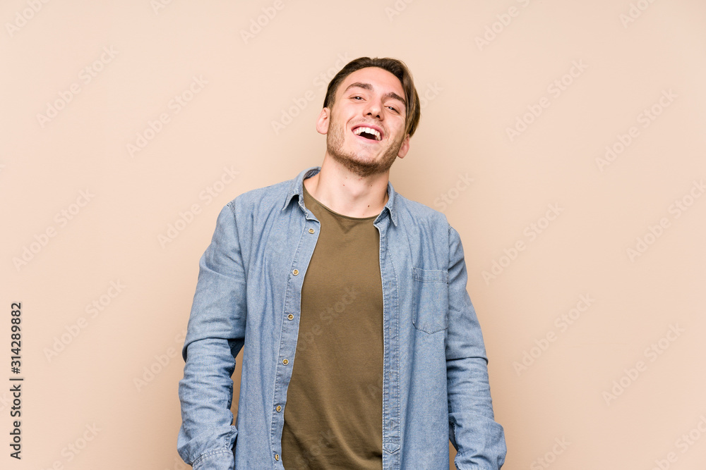 Young caucasian man posing isolated relaxed and happy laughing, neck stretched showing teeth. Young caucasian man posing isolated relaxed and happy laughing, neck stretched showing teeth.