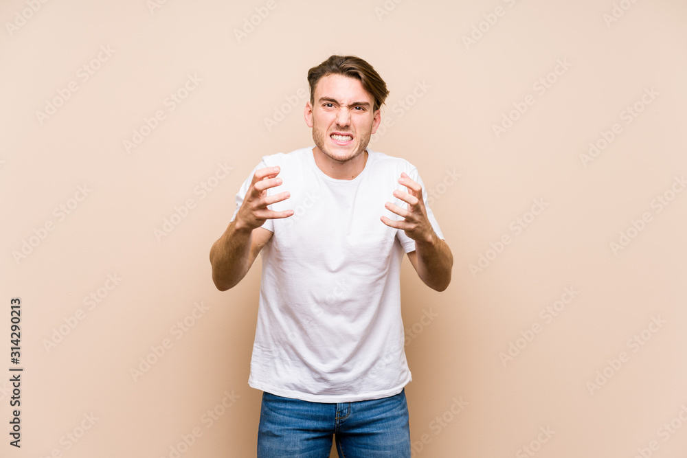 Young caucasian man posing isolated upset screaming with tense hands. Young caucasian man posing isolated upset screaming with tense hands.