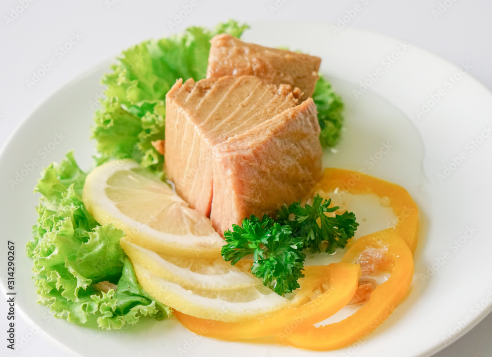Tuna chunk on white plate. Tuna chunk on white plate.
