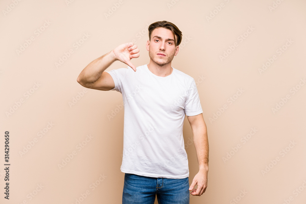 Young caucasian man posing isolated showing a dislike gesture, thumbs down. Disagreement concept. Young caucasian man posing isolated showing a dislike gesture, thumbs down. Disagreement concept.