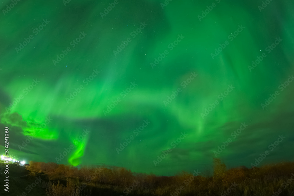 Aurora borealis in night northern sky. Ionization of air particl