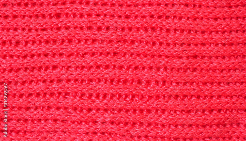 Knitted fabric texture. Red color. English knitting with front and back loops. Knitting on the knitting needles. Horizontal lines Knitted fabric texture. Red color. English knitting with front and back loops. Knitting on the knitting needles. Horizontal lines
