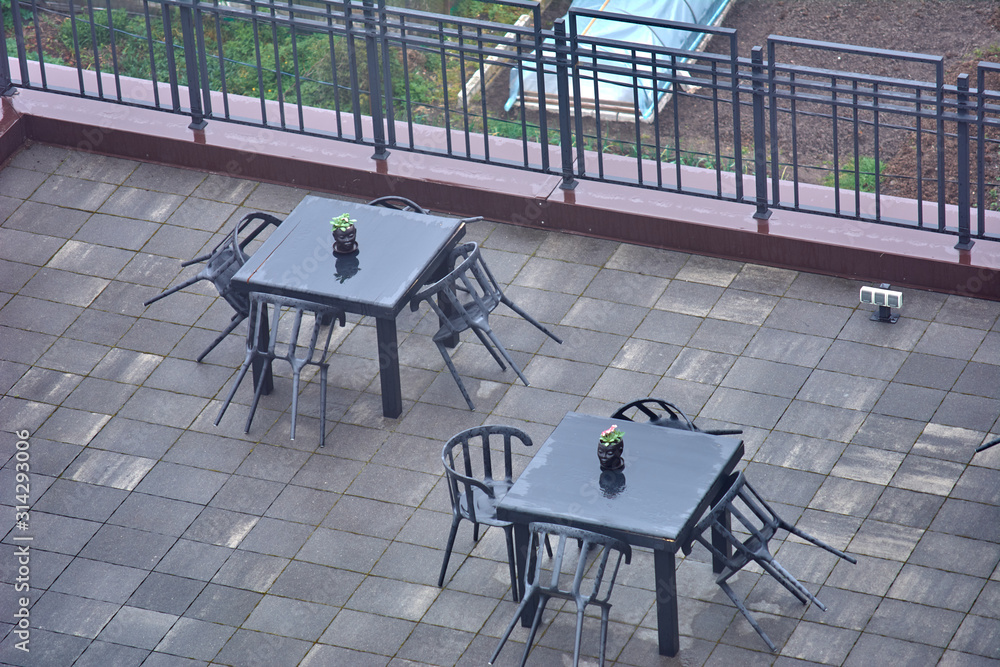 Two black tables in a cafe. View from above.