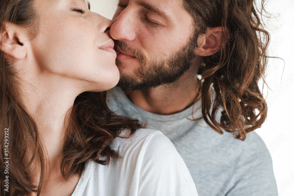 Kissing loving couple indoors at home. Kissing loving couple indoors at home.