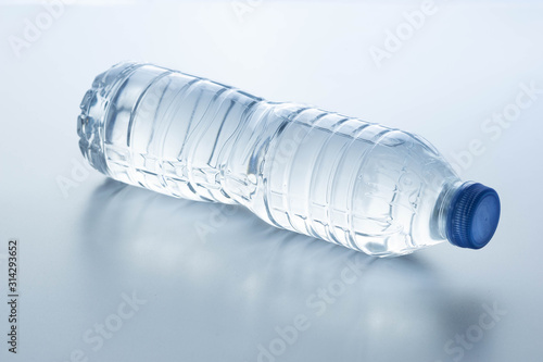 Plastic bottle lay down on white background.