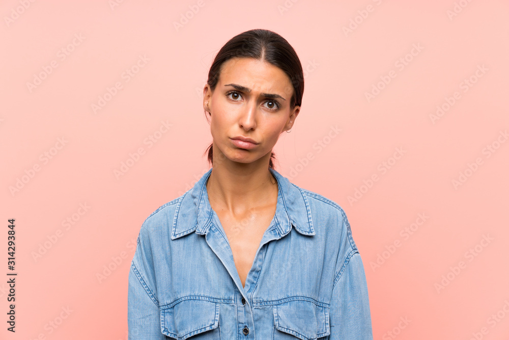 Young woman over isolated pink background sad Young woman over isolated pink background sad