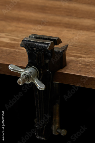 Bench vice on the desktop, the main tool for performing locksmith work.