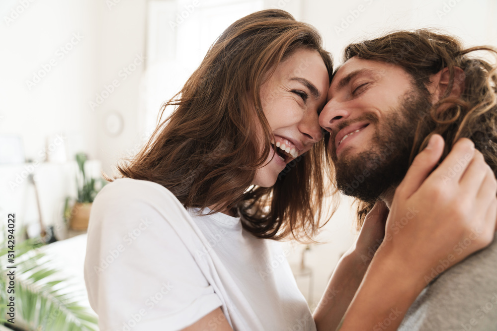 Loving couple indoors at home posing hugging. Loving couple indoors at home posing hugging.