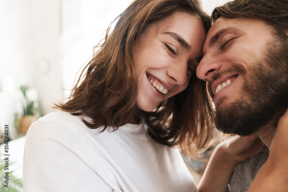 Loving couple indoors at home posing hugging.