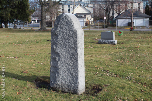 Tall gray granite gravestone at a small suburban Chicago cememtery photo