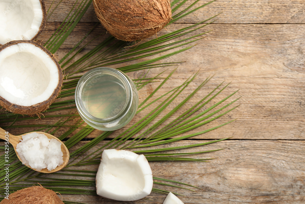 Flat lay composition with coconut oil on wooden table, space for text Flat lay composition with coconut oil on wooden table, space for text