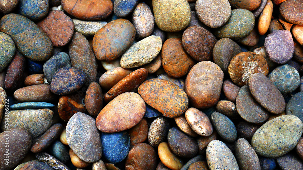 pebbles on the beach background, colorful smooth stone pebbles on the beach background, colorful smooth stone