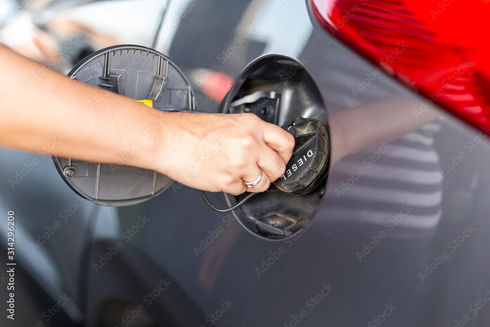 Woman opening car fuel tank