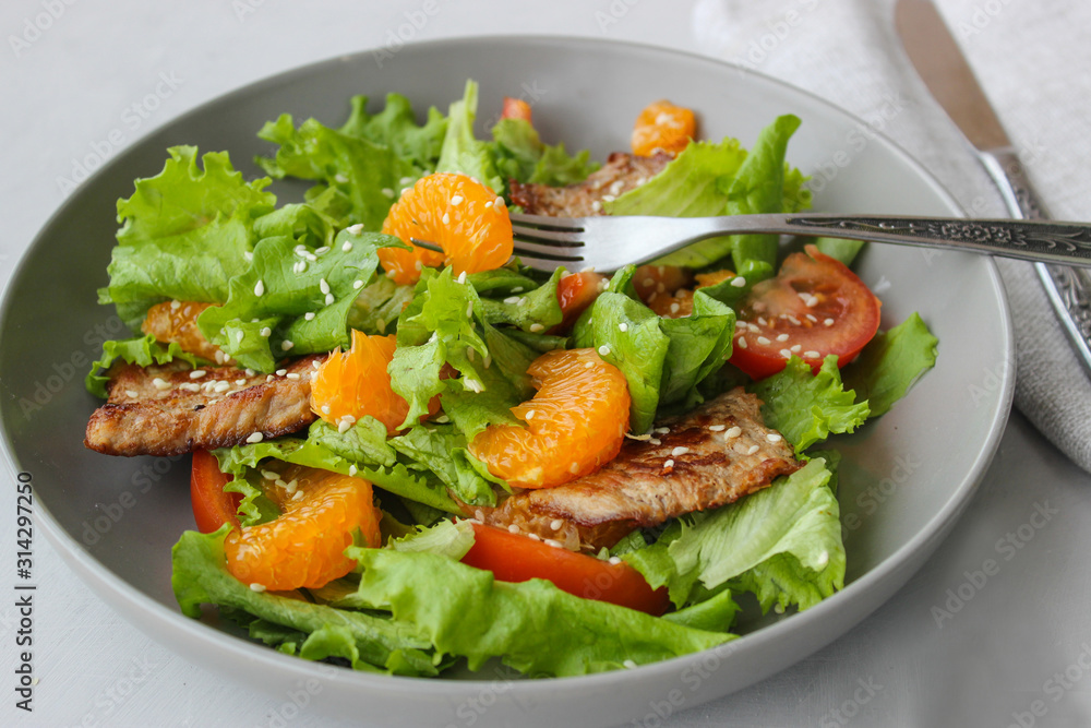 Salad with sweet tangerines and pieces of pork Salad with sweet tangerines and pieces of pork