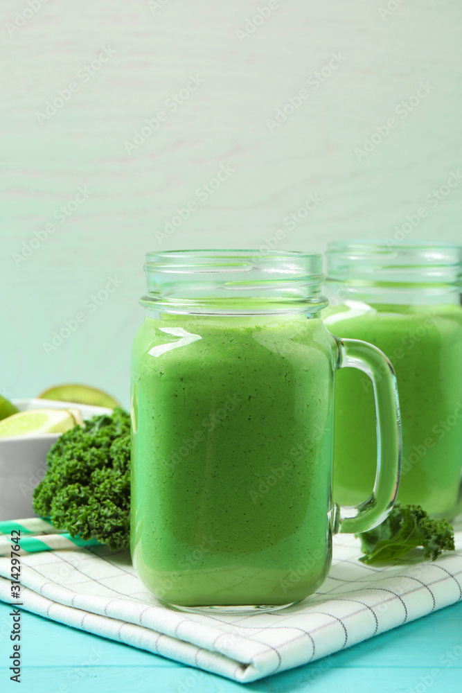 Tasty fresh kale smoothie on light blue wooden table Tasty fresh kale smoothie on light blue wooden table