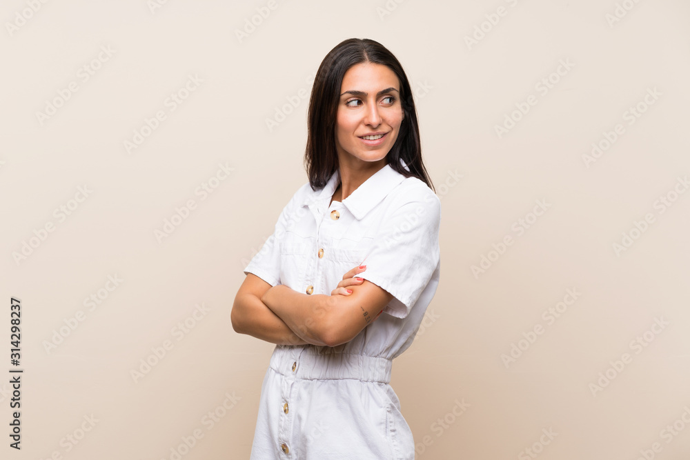 Young woman over isolated background with arms crossed and happy Young woman over isolated background with arms crossed and happy