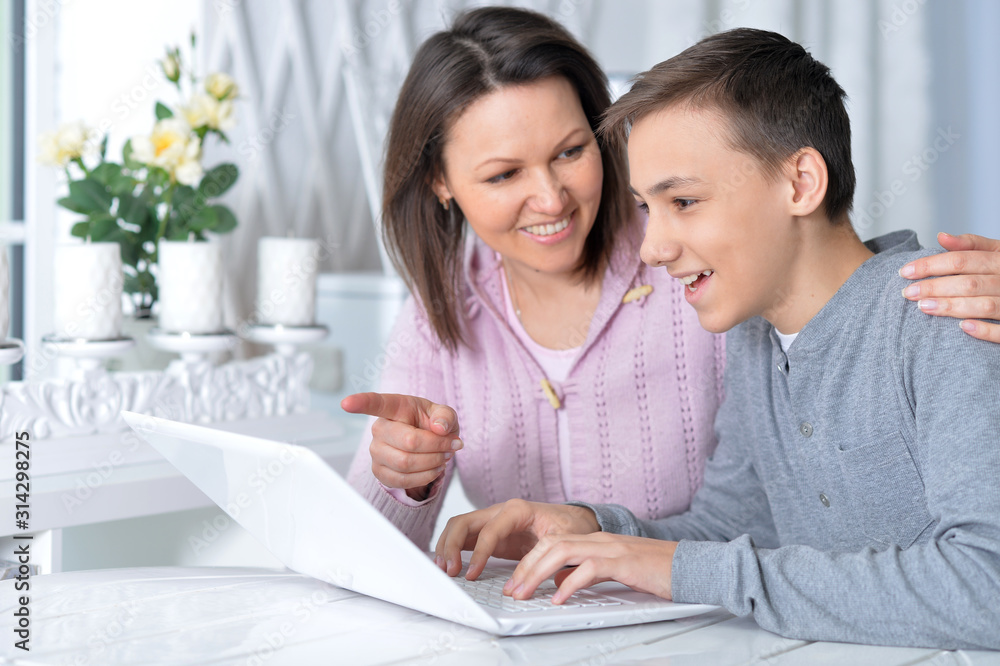 Emotional mother and son using modern laptop Emotional mother and son using modern laptop