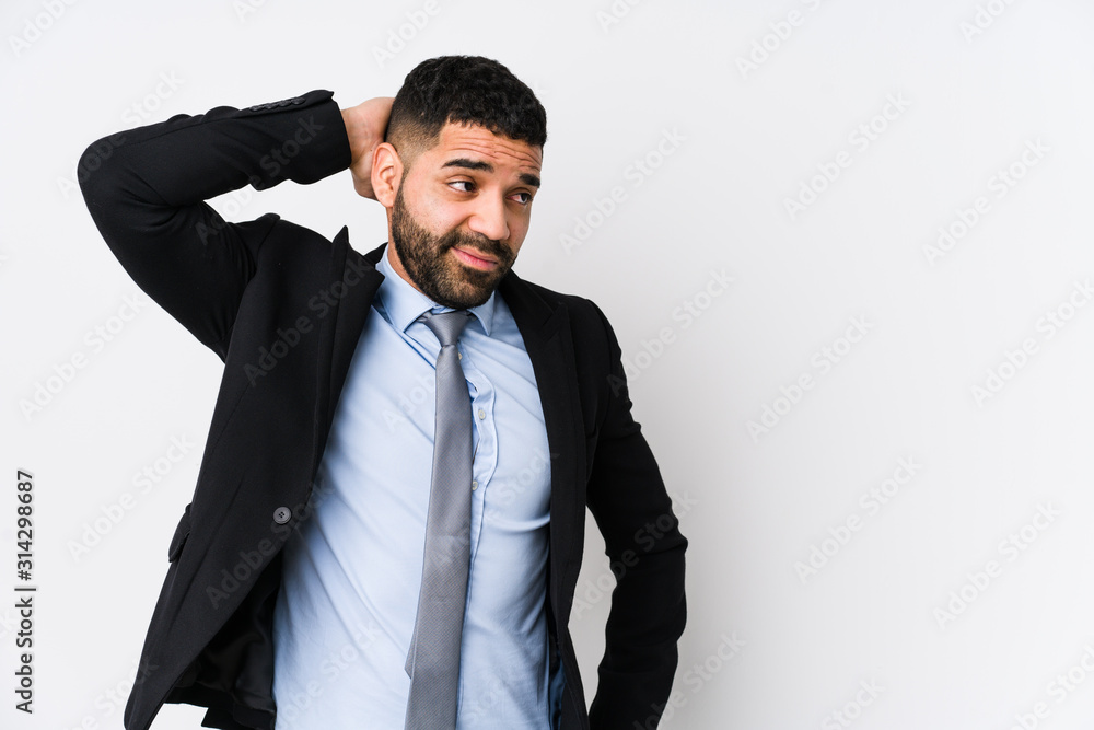 Young latin business woman against a white background isolated touching back of head, thinking and making a choice. Young latin business woman against a white background isolated touching back of head, thinking and making a choice.