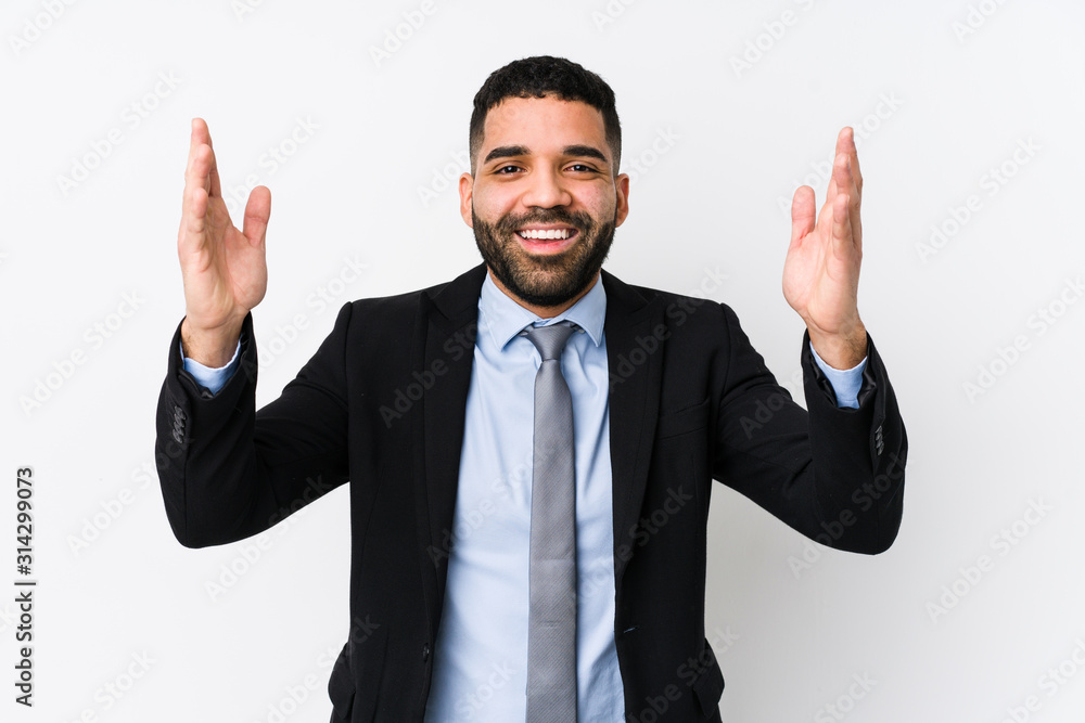 Young latin business woman against a white background isolated receiving a pleasant surprise, excited and raising hands. Young latin business woman against a white background isolated receiving a pleasant surprise, excited and raising hands.