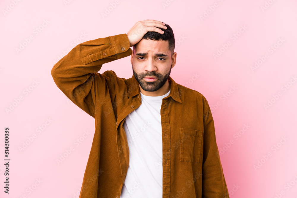 Young latin man against a pink background isolated being shocked, she has remembered important meeting. Young latin man against a pink background isolated being shocked, she has remembered important meeting.