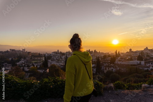 silhouette of woman on top of mountain at sunset