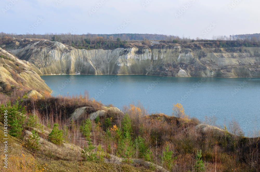 Chalk quarry artificial lakes in autumn season. Technogenic open pit is known as the Belarusian Maldives, which is in great demand among tourists from around the world