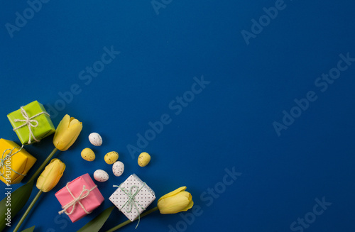 Easter holiday background. Easter eggs in pastel colors on a blue background