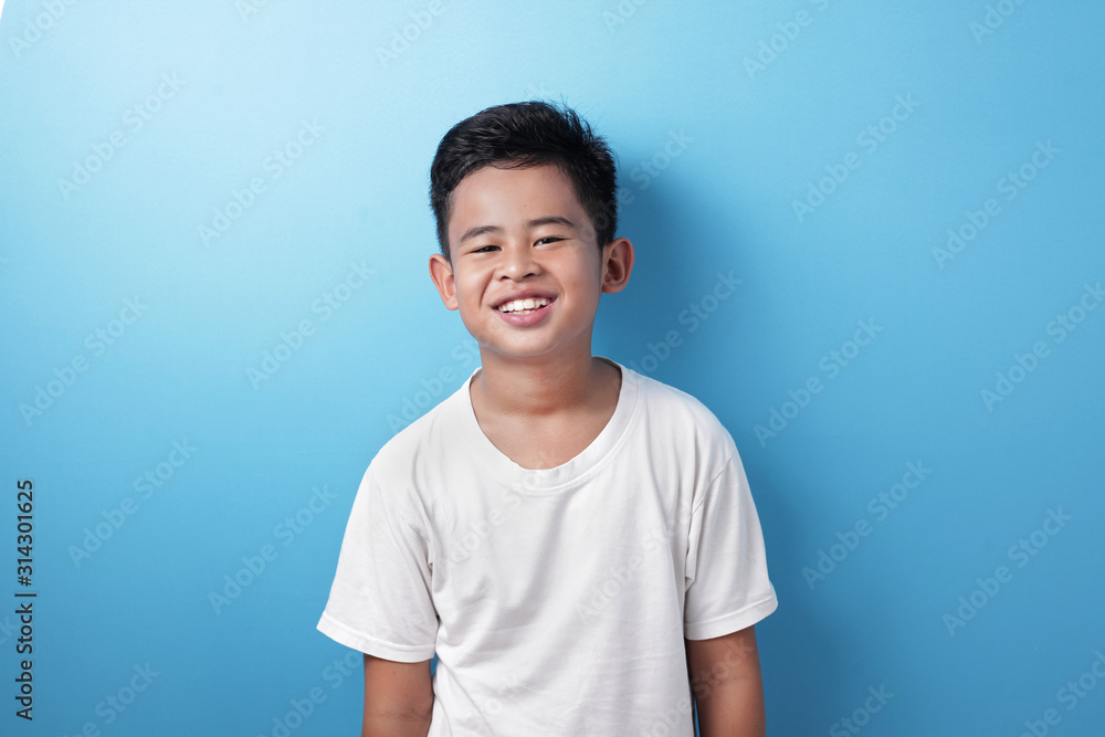 Cute Asian Boy Looking at Camera and Smiling Happily Cute Asian Boy Looking at Camera and Smiling Happily