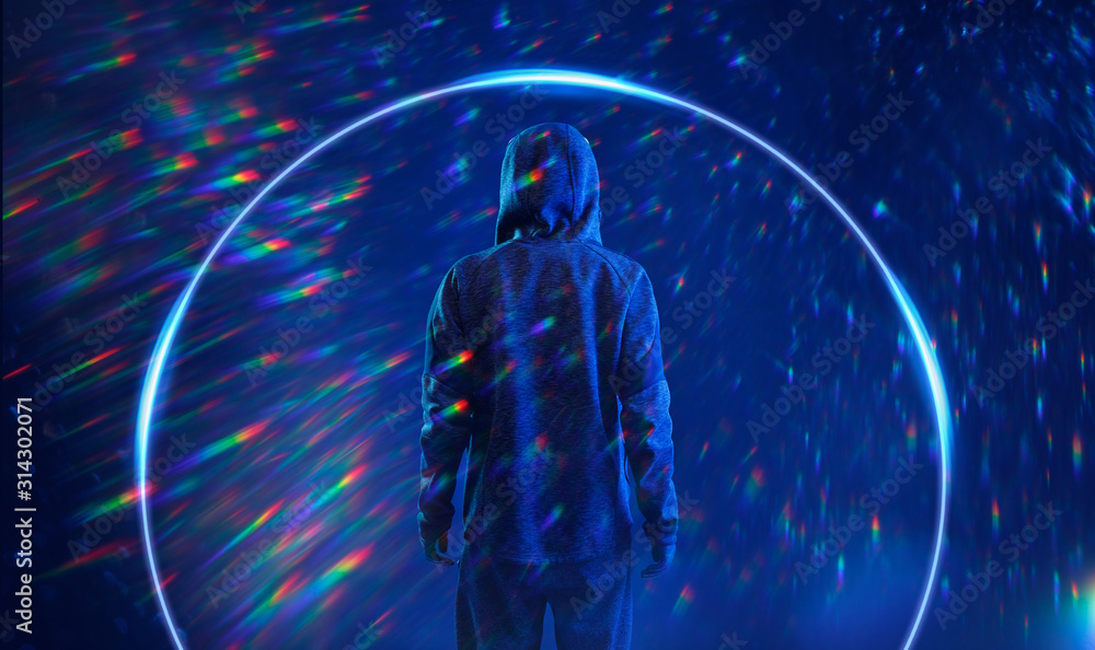 Back view of hacker in hoodie. Dangerous hooded hacker. Internet, cyber crime, cyber attack, system breaking and malware concept. Anonymous. Dark background. Rainbow flares. Blue neon light. Back view of hacker in hoodie. Dangerous hooded hacker. Internet, cyber crime, cyber attack, system breaking and malware concept. Anonymous. Dark background. Rainbow flares. Blue neon light.