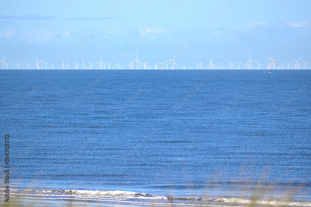 Offshore wind farm in the north sea as seen from the beach Offshore wind farm in the north sea as seen from the beach