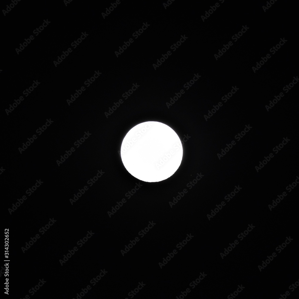 White moon focused out in dark night sky White moon focused out in dark night sky