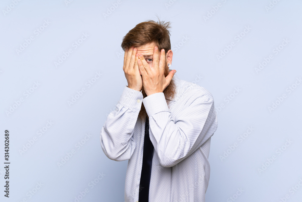 Businessman with long beard over isolated background covering eyes and looking through fingers Businessman with long beard over isolated background covering eyes and looking through fingers
