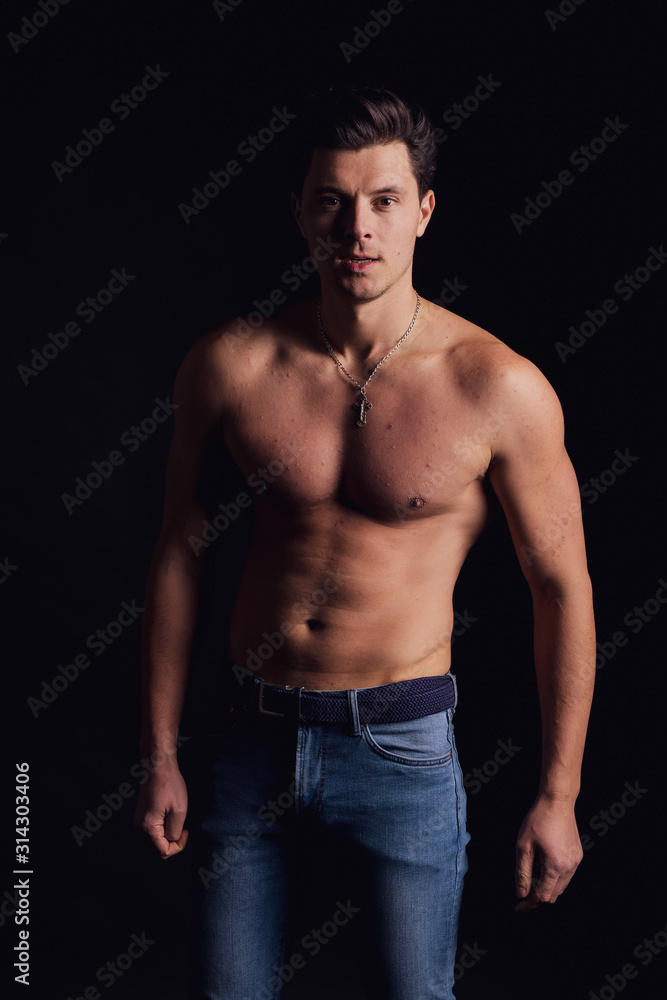 barechested guy with a dramatic light in the Studio. the average plan goes to the camera barechested guy with a dramatic light in the Studio. the average plan goes to the camera