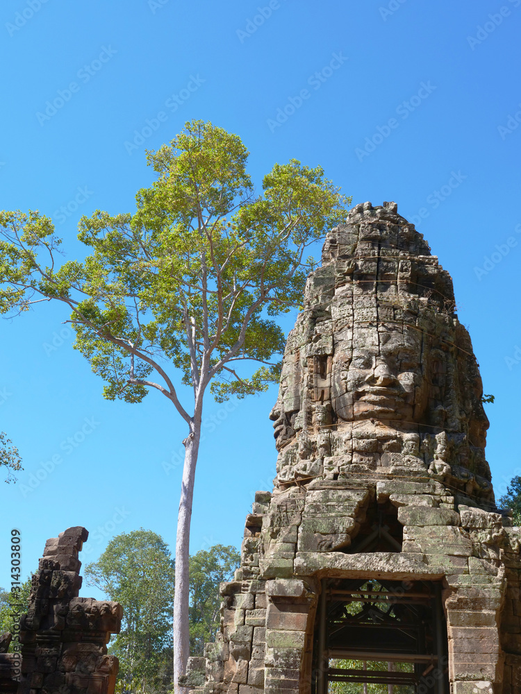 Stone rock carving art of face at Banteay Kdei, part of the Angkor wat complex in Siem Reap, Cambodia Stone rock carving art of face at Banteay Kdei, part of the Angkor wat complex in Siem Reap, Cambodia