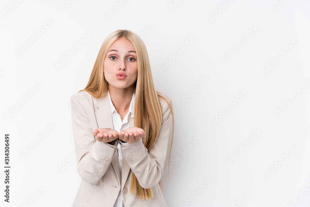 Young business blonde woman on white background folding lips and holding palms to send air kiss. Young business blonde woman on white background folding lips and holding palms to send air kiss.