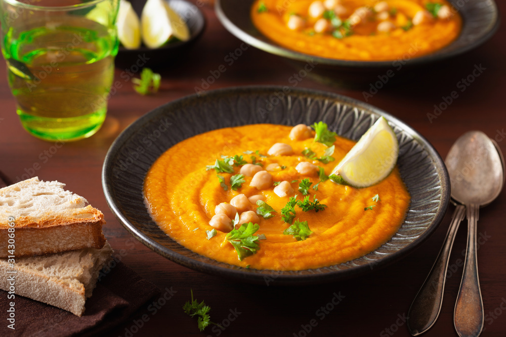 creamy carrot chickpea soup on dark rustic background creamy carrot chickpea soup on dark rustic background