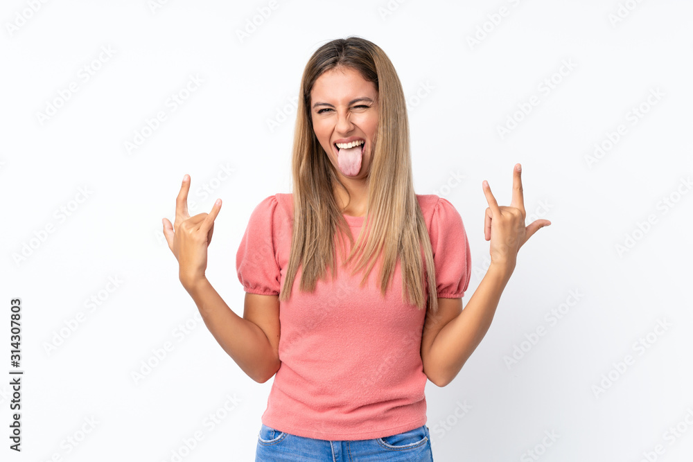 Young blonde woman over isolated white background making rock gesture Young blonde woman over isolated white background making rock gesture