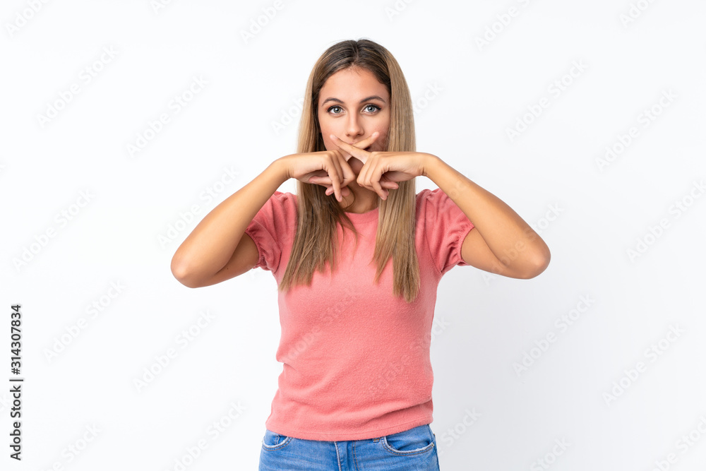 Fototapeta premium Young blonde woman over isolated white background showing a sign of silence gesture