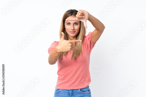 Young blonde woman over isolated white background focusing face. Framing symbol