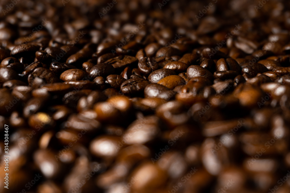 Close up of fresh roasted brown coffee beans - angled view Close up of fresh roasted brown coffee beans - angled view