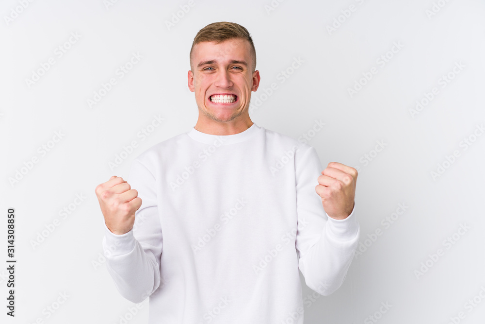 Young caucasian man on white background cheering carefree and excited. Victory concept. Young caucasian man on white background cheering carefree and excited. Victory concept.