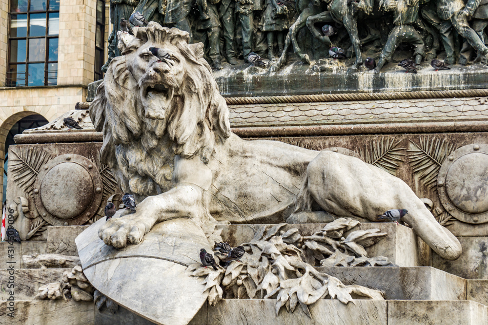 Lion on the pedestal of the monument to Victor Emmanuel II in Milan, Italy