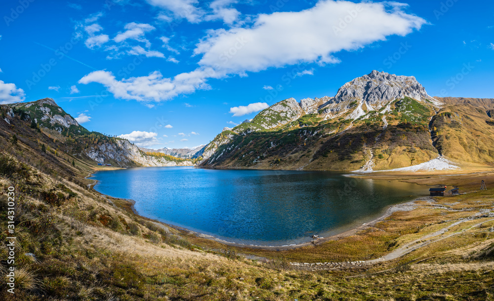 Naklejka premium Sunny autumn alpine Tappenkarsee lake and rocky mountains above, Kleinarl, Land Salzburg, Austria.
